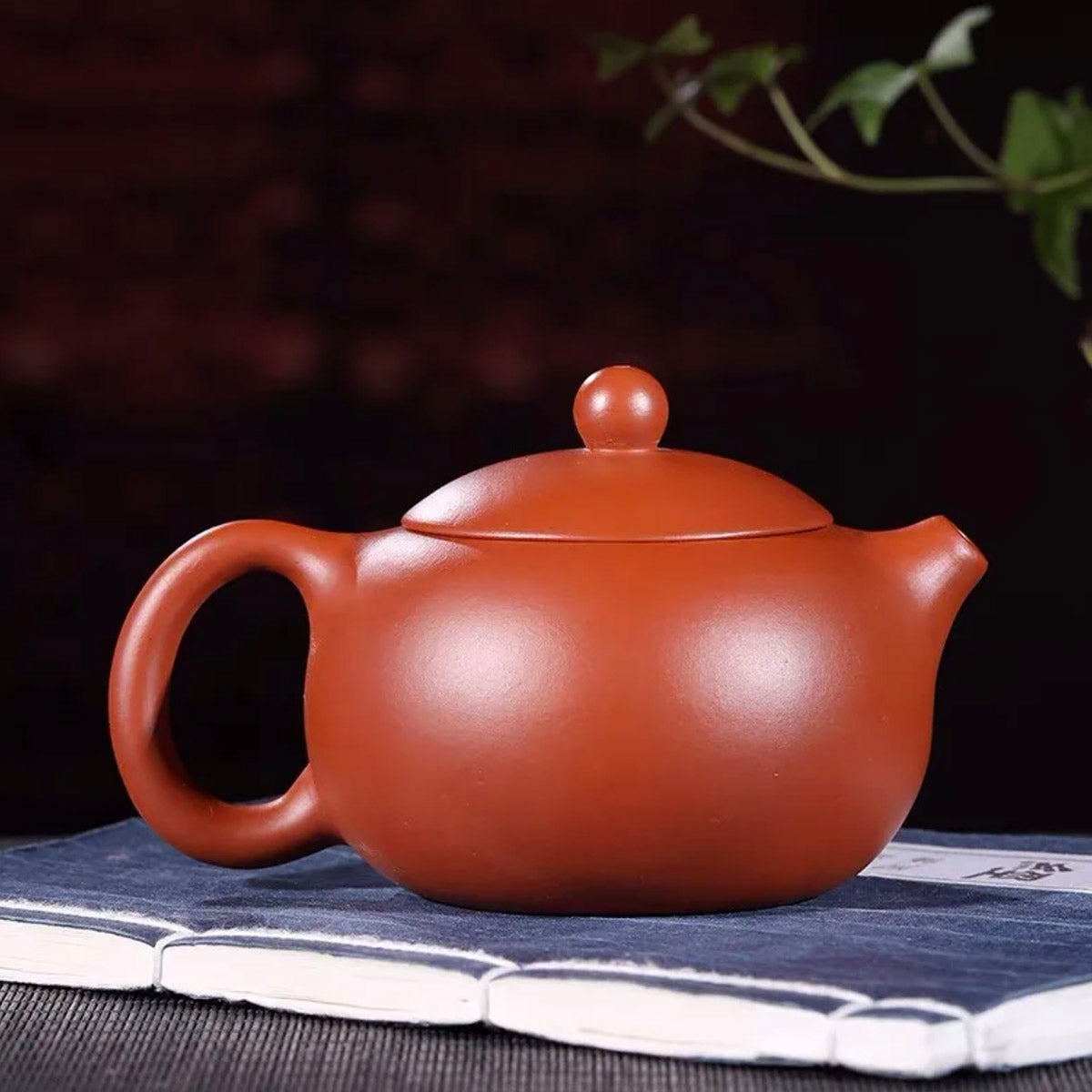 Red clay teapot on a dark background